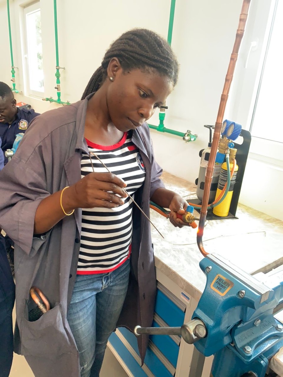 Trainee brazing a copper pipe with a torch