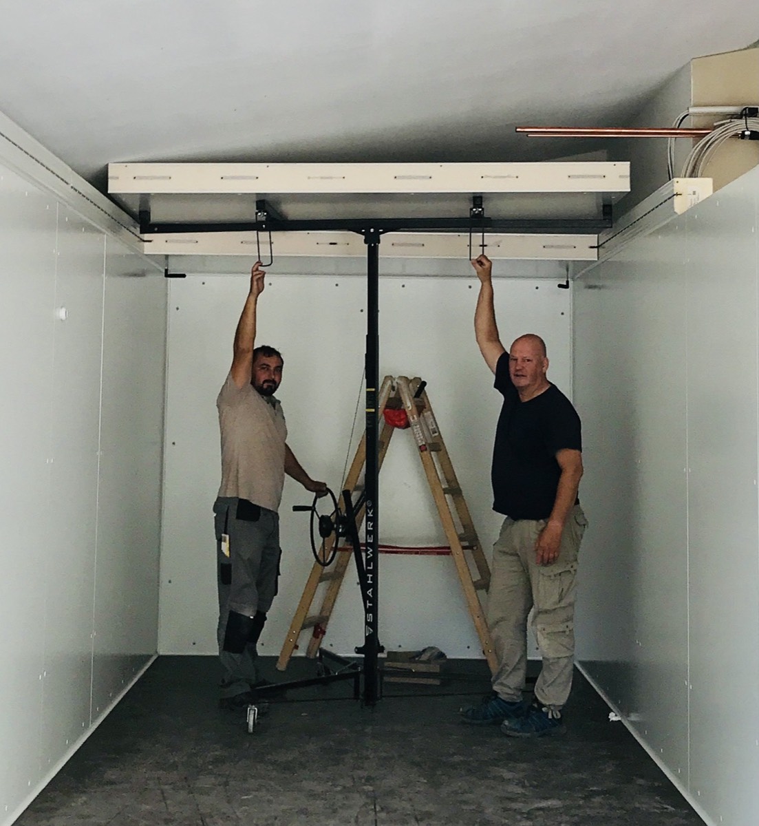 Technicians fitting the evaporator inside a new cold room