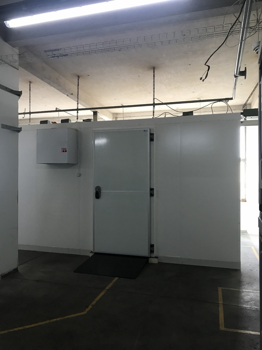 Completed walk-in cold room with door and cooling unit