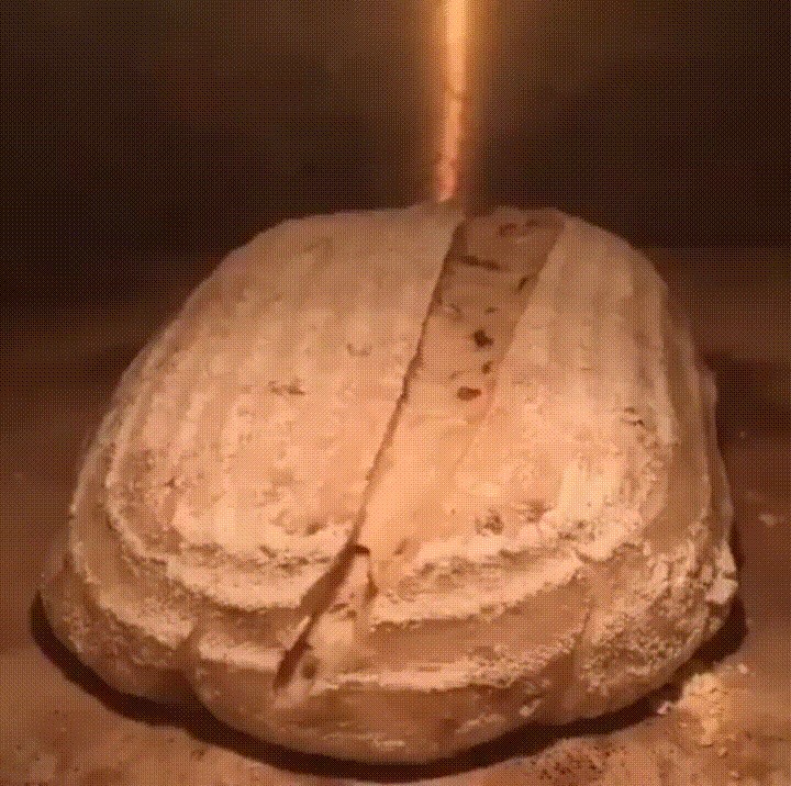 Scoring a loaf of bread before baking