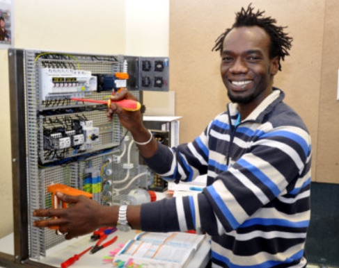 Trainee wiring an electrical control panel
