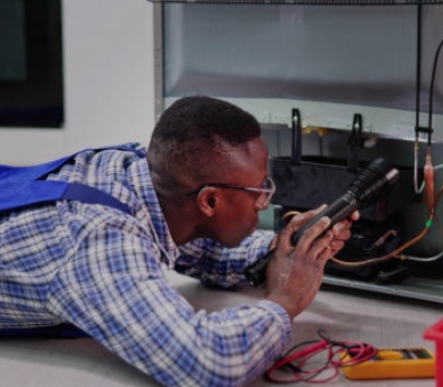 Technician measuring a refrigeration unit with a multimeter