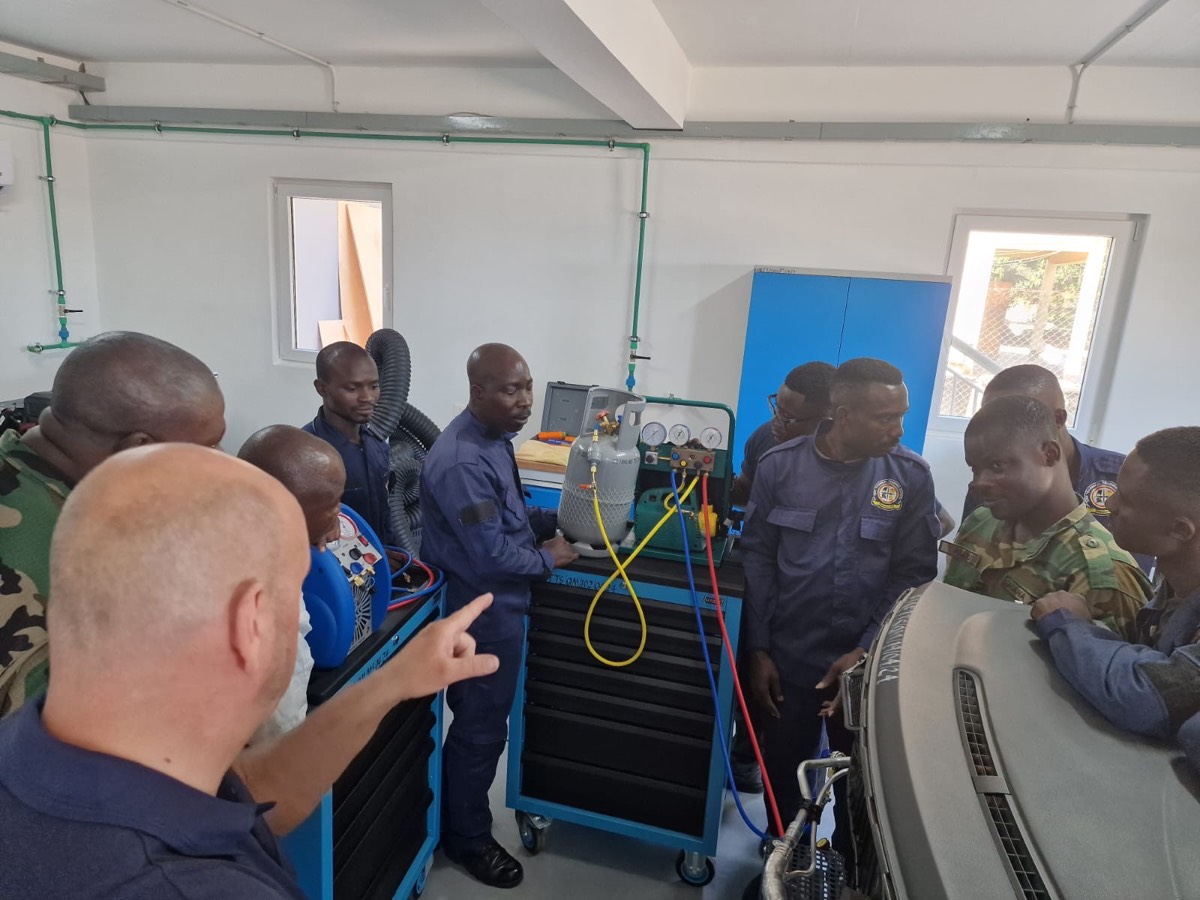 Instructor at the refrigerant charging station with gauges