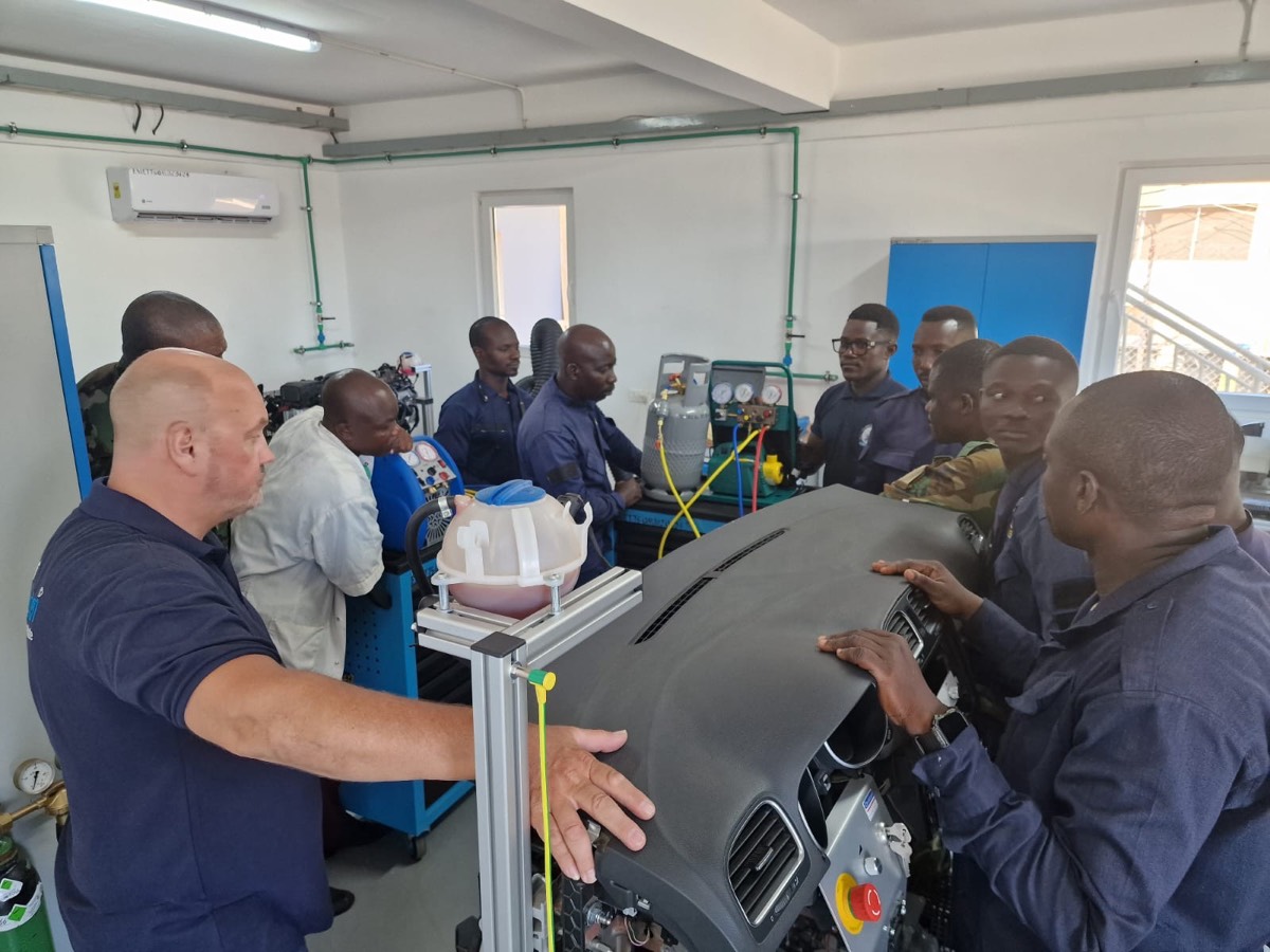 Trainees around the vehicle air-conditioning trainer